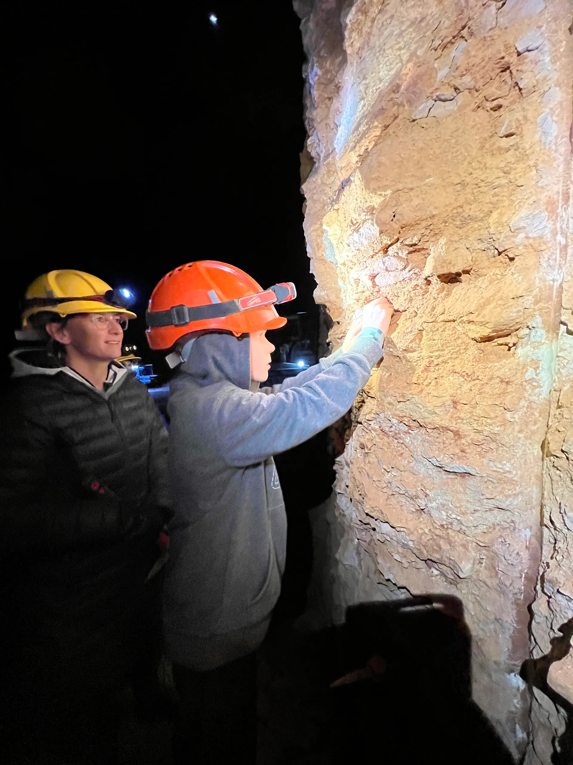 A young guest mining with an adult beside them